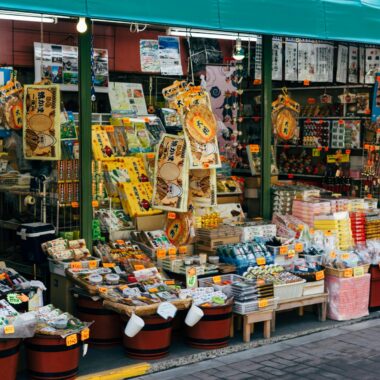 Vibrant outdoor storefront in Hachioji, Tokyo showcasing traditional Japanese souvenirs and goods.